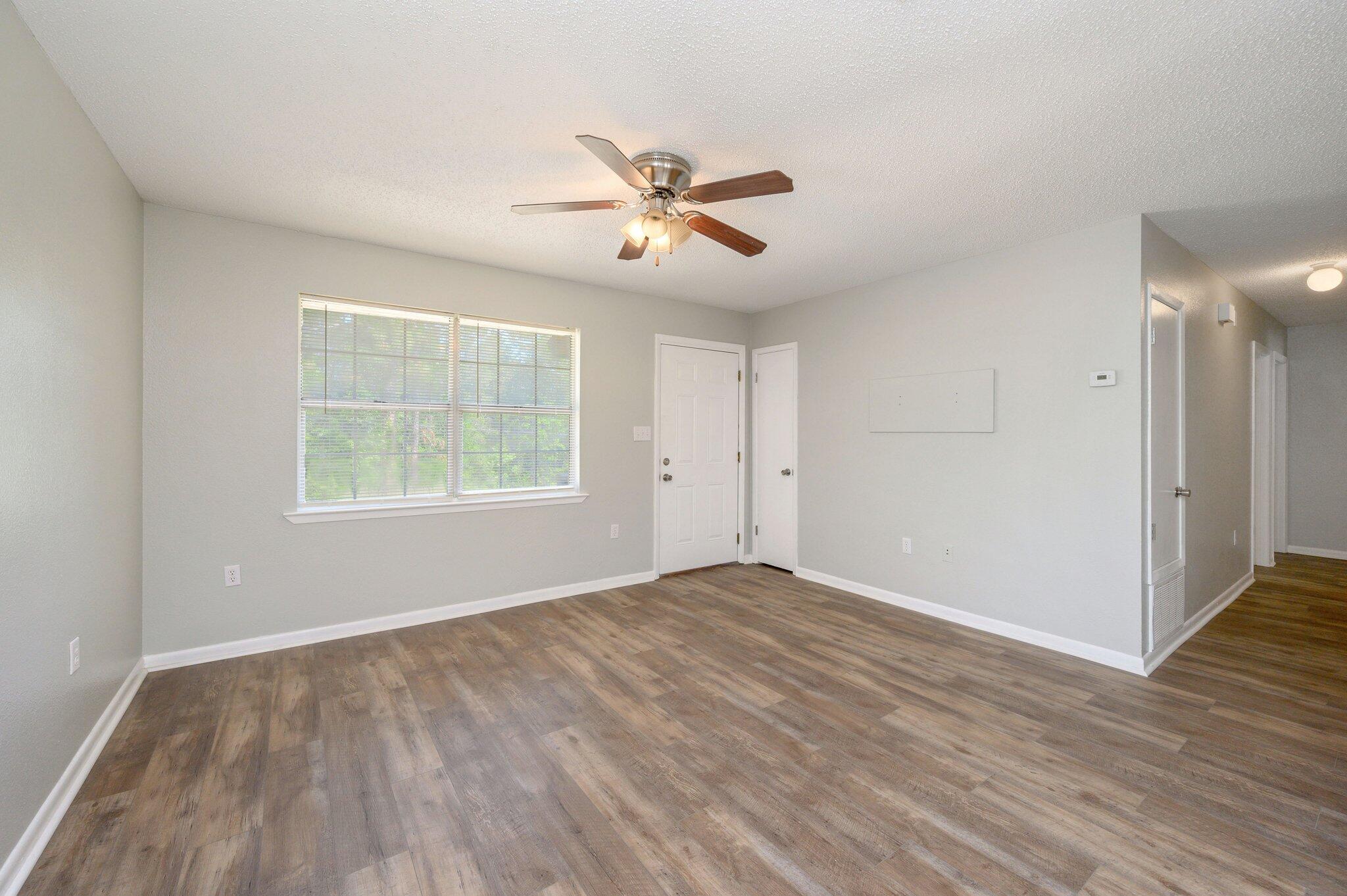 3970 Indian Mound Road Crestview, FL 32539 - Photo 6 of 33 wooden floor in an empty room with a window