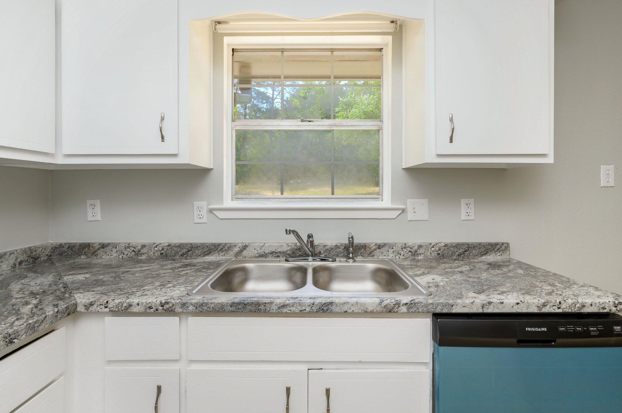 3970 Indian Mound Road Crestview, FL 32539 - Photo 9 of 33 a kitchen with granite countertop a sink and a window