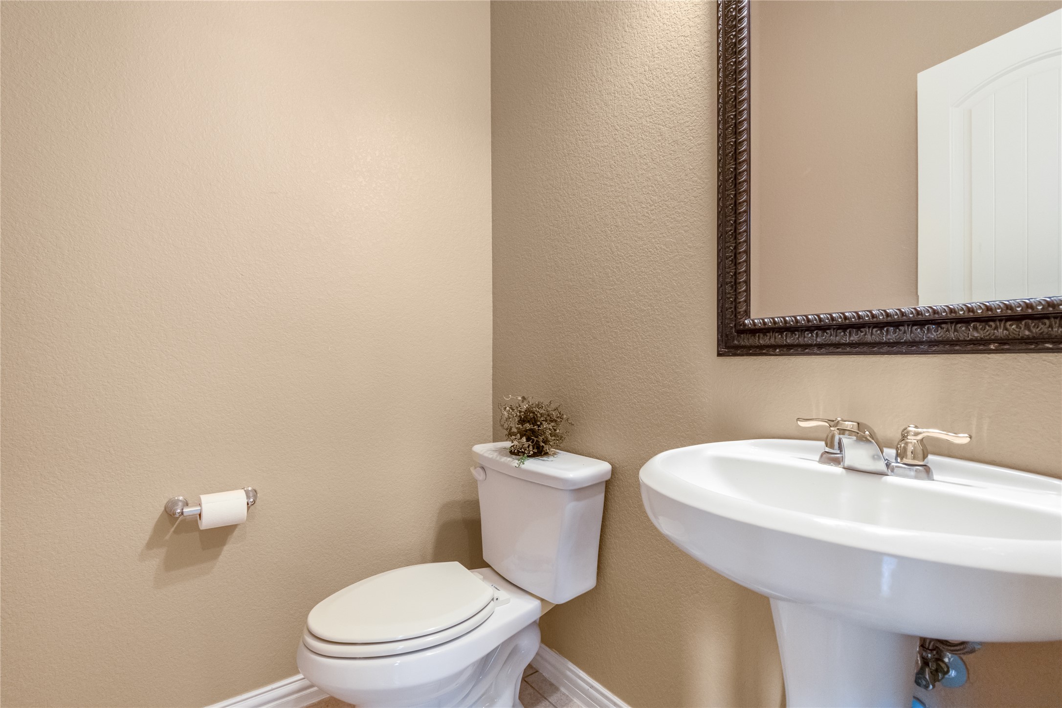 3413 Grail Hollows Road Pflugerville, TX 78660 - Photo 13 of 36 a bathroom with a sink a toilet and a mirror