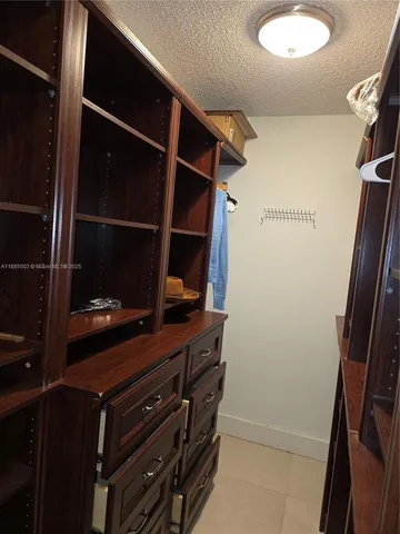 a room with wooden floor and mirror