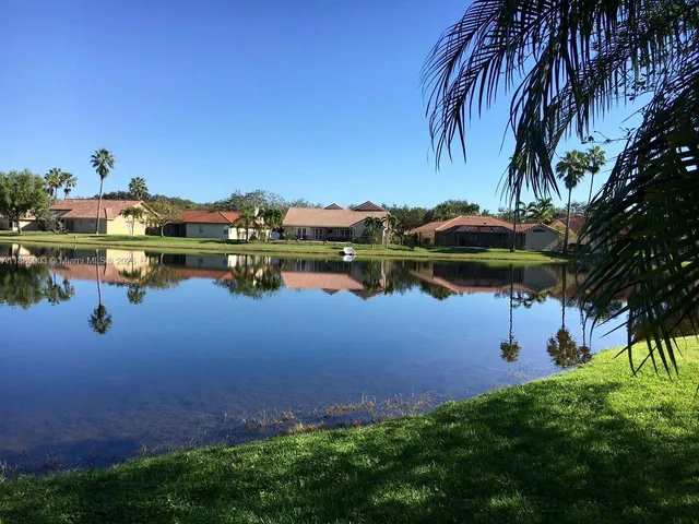 a view of a lake with houses in the back