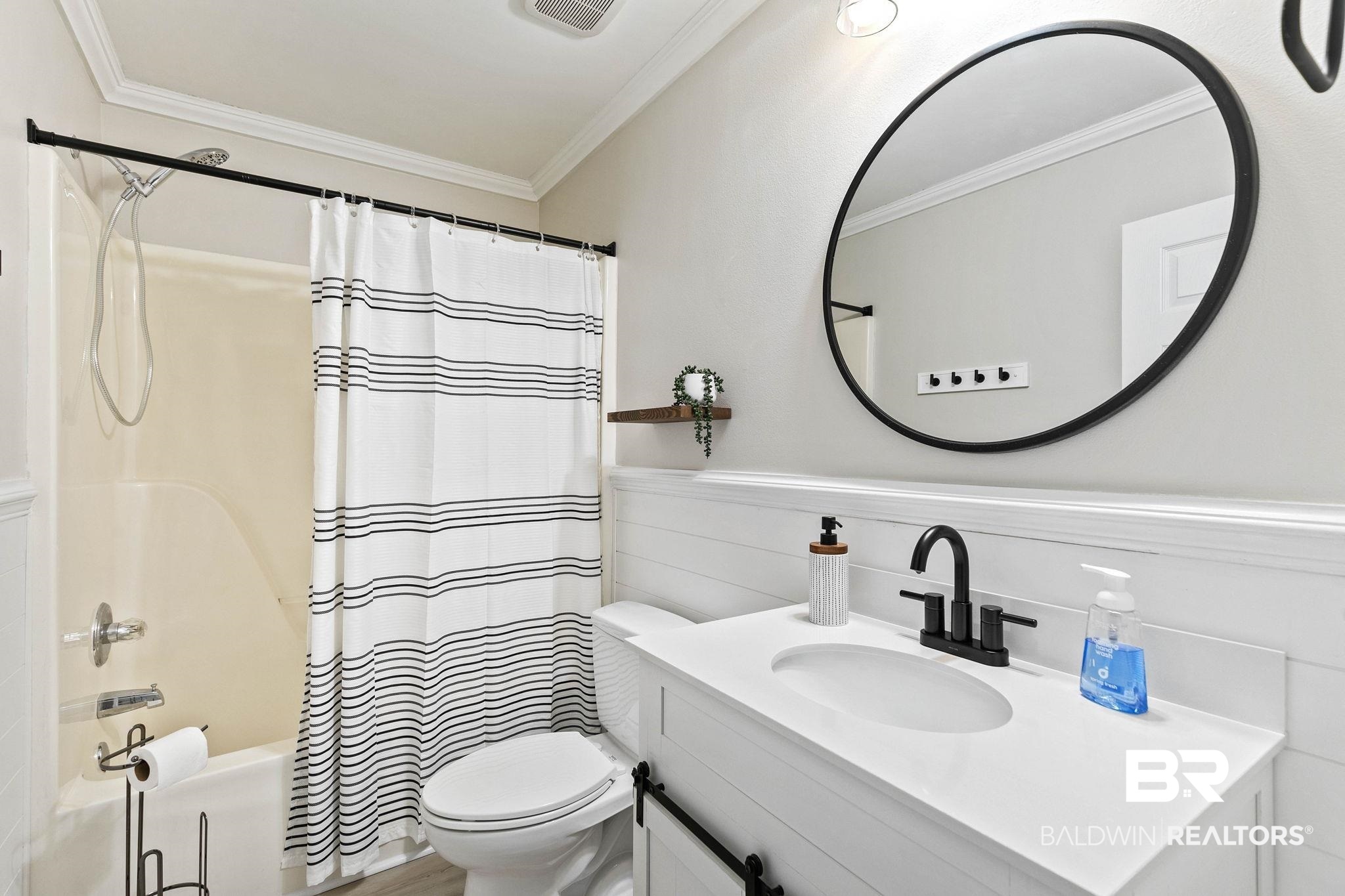 35650 Spring Road North Stapleton, AL 36578 - Photo 45 of 70 Bathroom with shower / bath combination with curtain, a wainscoted wall, vanity, and crown molding