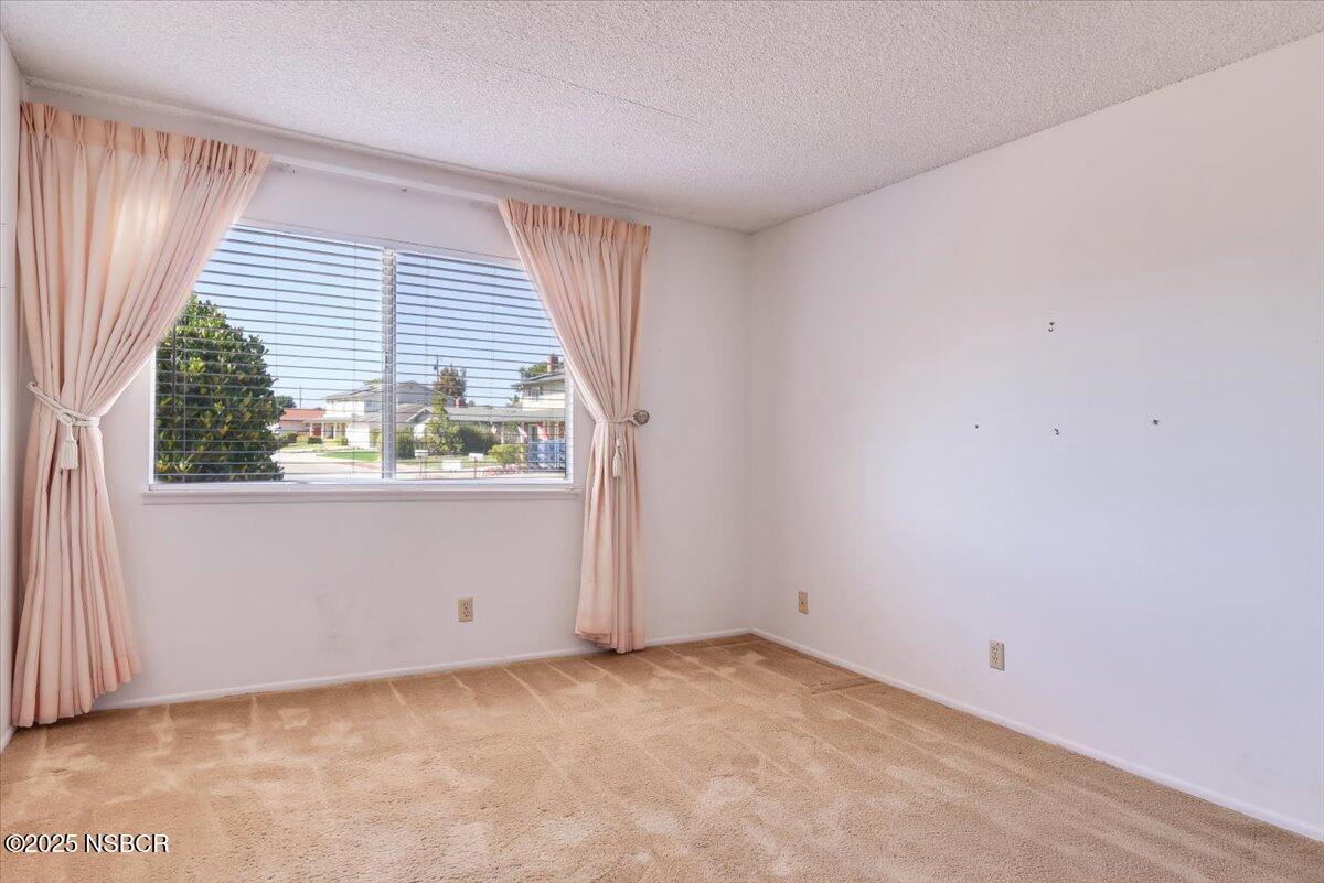 244 Pegasus Avenue Lompoc, CA 93436 - Photo 23 of 28 an empty room with wooden floor and windows