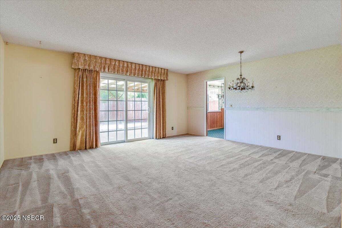 244 Pegasus Avenue Lompoc, CA 93436 - Photo 4 of 28 a view of a livingroom with a chandelier fan and windows