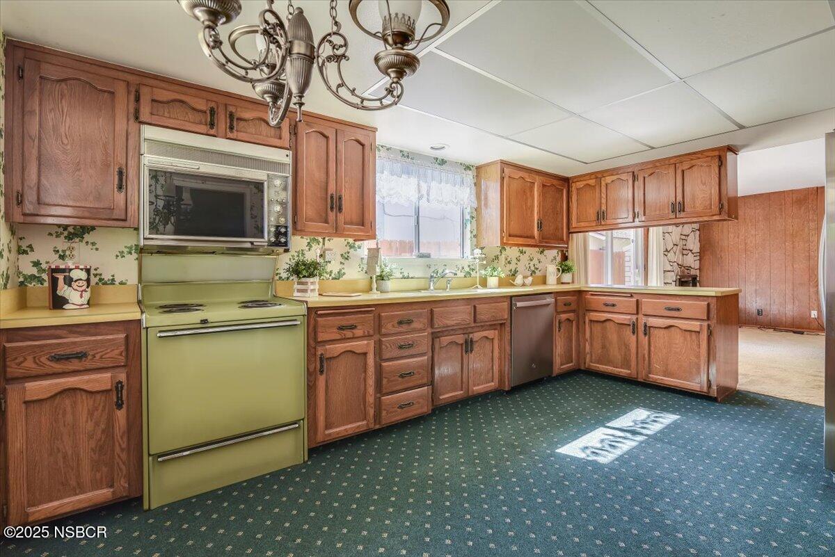 244 Pegasus Avenue Lompoc, CA 93436 - Photo 6 of 28 a kitchen with a sink cabinets stainless steel appliances and a window