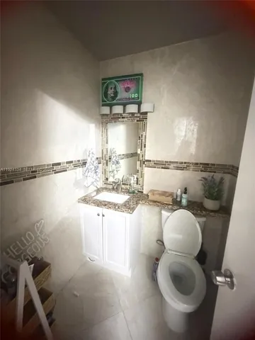 a kitchen with a sink cabinets and toilet