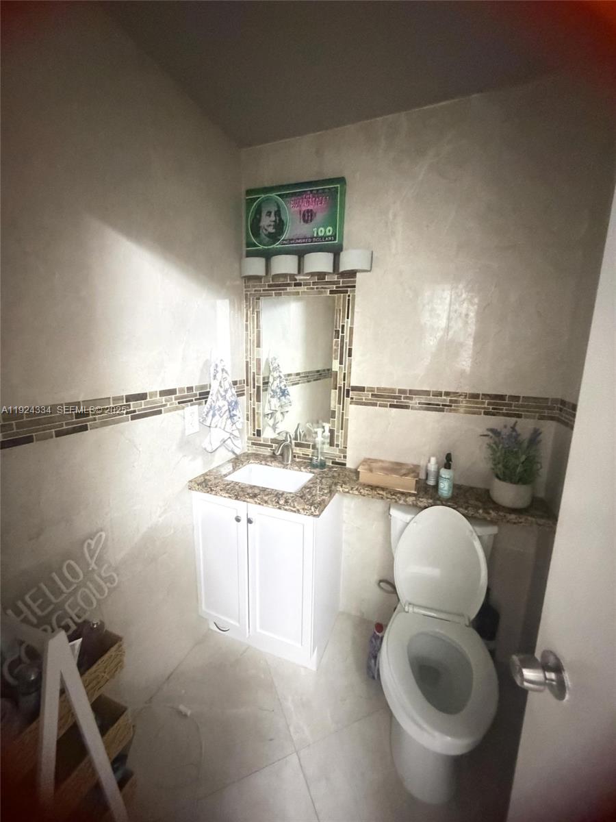 3001 Northwest 4th Terrace, Unit 158 Pompano Beach, FL 33064 - Photo 12 of 23 a kitchen with a sink cabinets and toilet