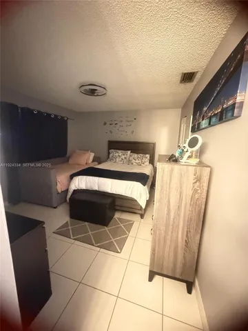a bedroom with a bed and a mirror