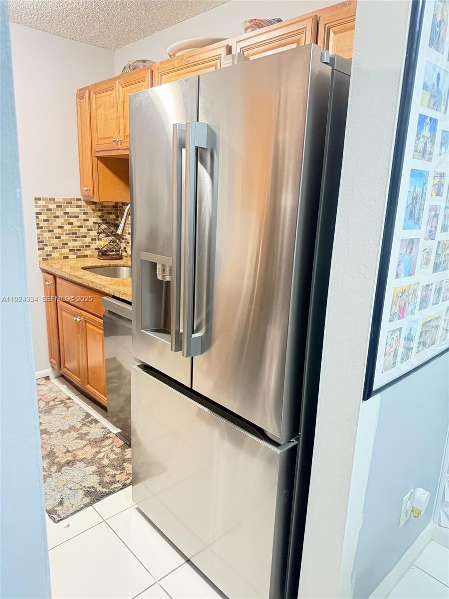 3001 Northwest 4th Terrace, Unit 158 Pompano Beach, FL 33064 - Photo 3 of 23 a view of walk in closet with wooden floor