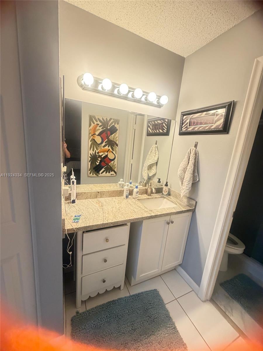 3001 Northwest 4th Terrace, Unit 158 Pompano Beach, FL 33064 - Photo 10 of 23 a bathroom with a double vanity sink and a mirror
