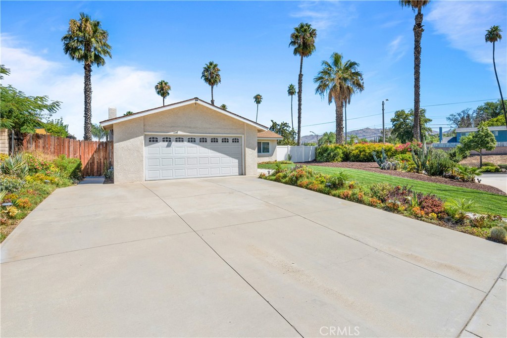 2111 Whitestone Drive Riverside, CA 92506 - Photo 2 of 17 a white house with a yard and palm trees