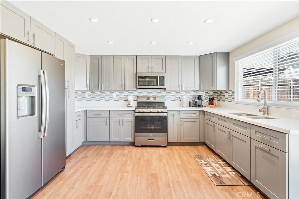 2111 Whitestone Drive Riverside, CA 92506 - Photo 4 of 17 a kitchen with a sink cabinets stainless steel appliances and a window