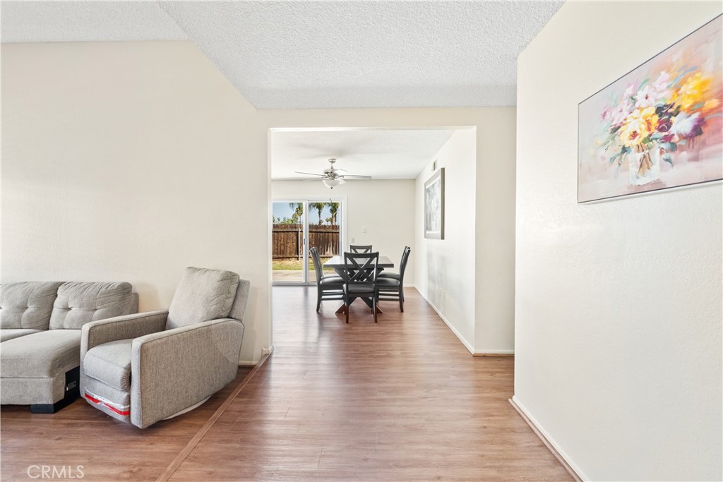 2111 Whitestone Drive Riverside, CA 92506 - Photo 5 of 17 a living room with furniture and a dining table with wooden floor