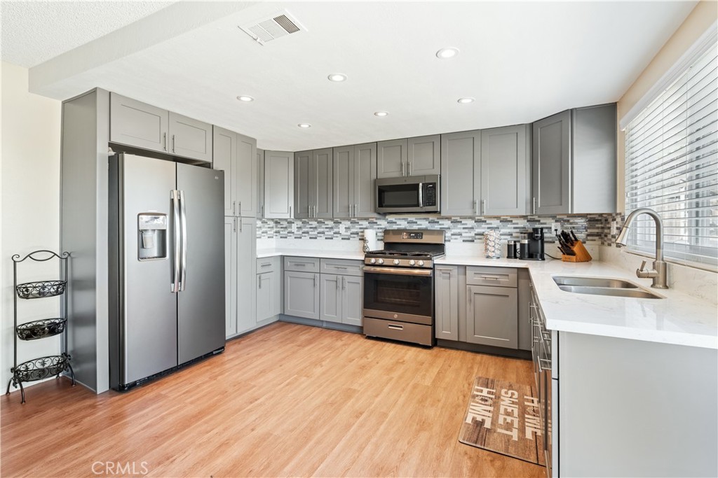 2111 Whitestone Drive Riverside, CA 92506 - Photo 6 of 17 a kitchen with stainless steel appliances a refrigerator stove and sink