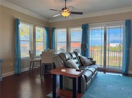a kitchen with stainless steel appliances granite countertop a sink a stove a dining table and chairs