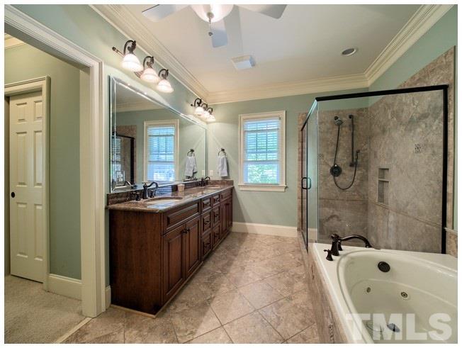 9709 Bailey Grove Court Raleigh, NC 27613 - Photo 14 of 25 a large bathroom with a tub sink shower and mirror