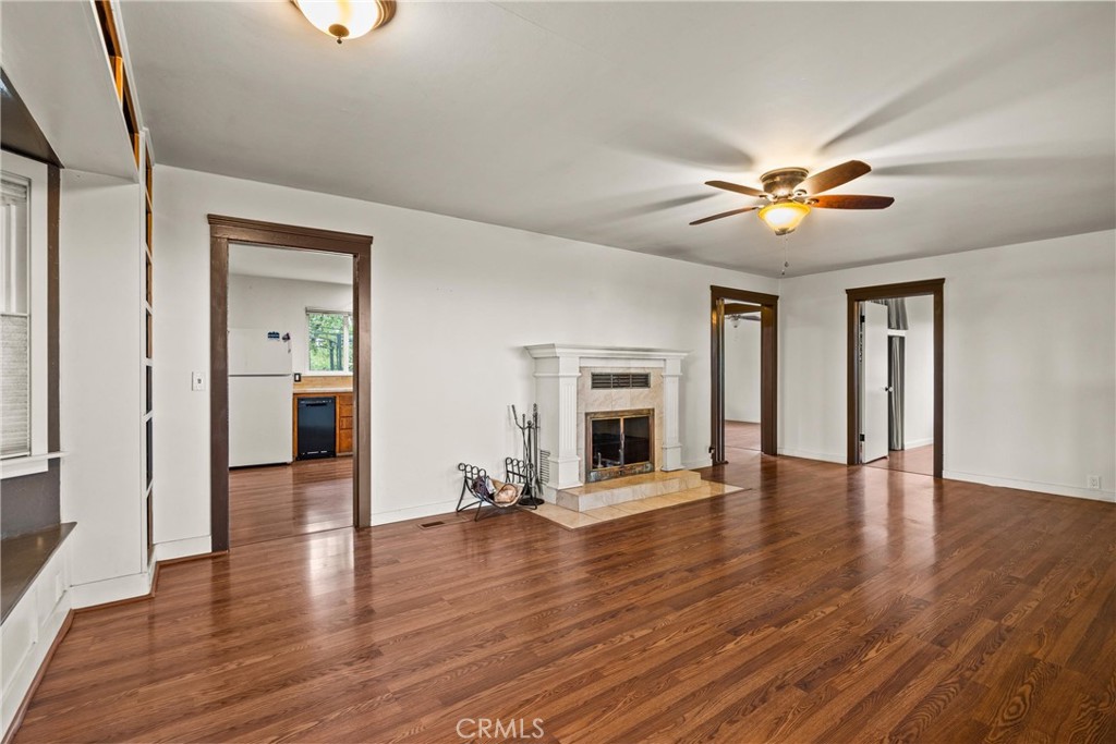 5416 Foster Road Paradise, CA 95969 - Photo 11 of 30 a view of a livingroom with a fireplace a ceiling fan and wooden floor