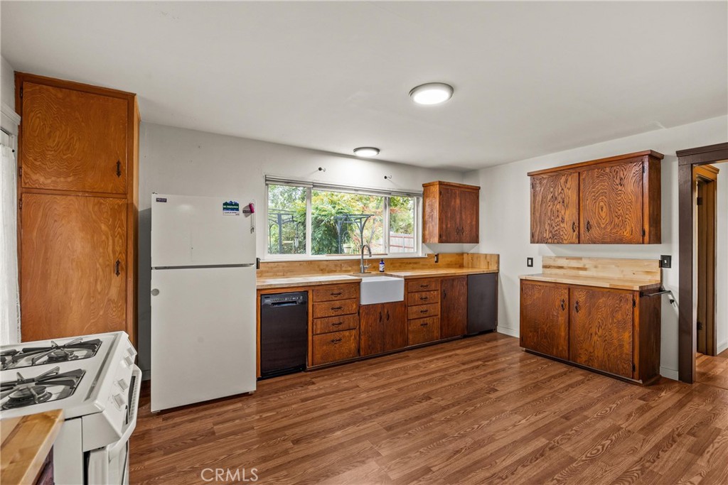 5416 Foster Road Paradise, CA 95969 - Photo 14 of 30 a kitchen with a stove a sink dishwasher a refrigerator and a stove top oven
