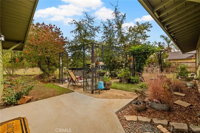 a view of a house with backyard porch and sitting area