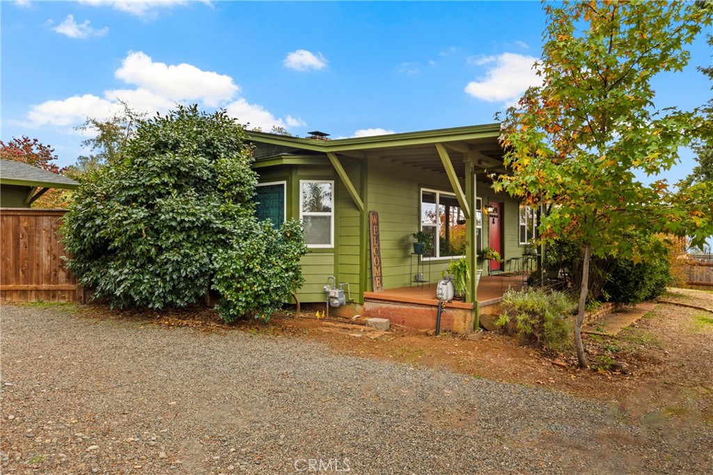 5416 Foster Road Paradise, CA 95969 - Photo 6 of 30 a view of backyard with a table and chairs and potted plants