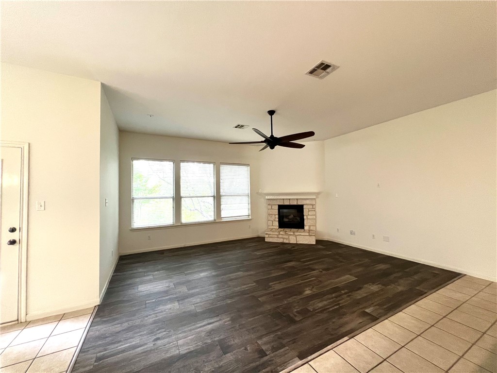 507 Red Hawk Drive Leander, TX 78641 - Photo 6 of 14 a view of empty room with wooden floor and fan