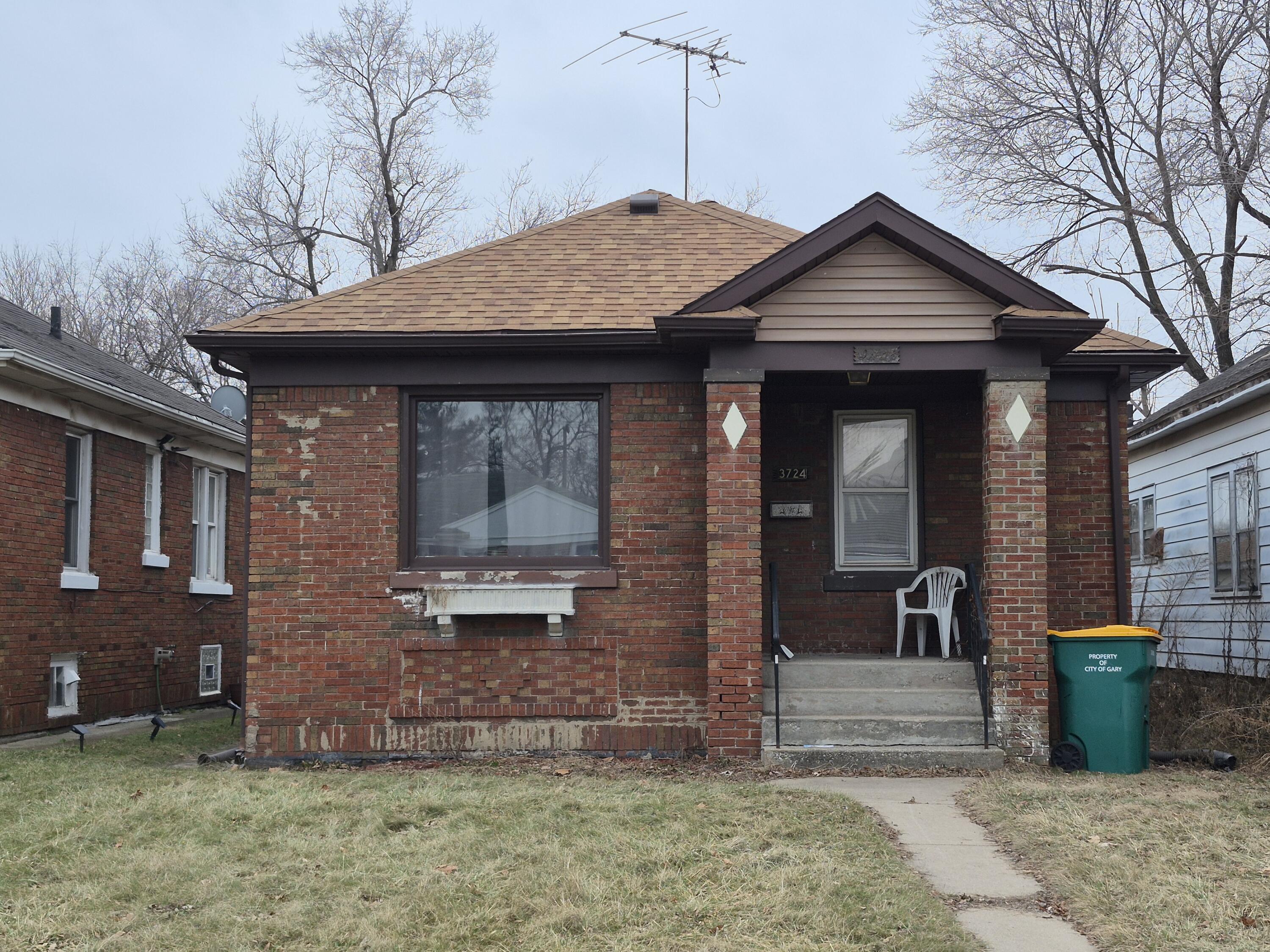 3724 Tyler Street Gary, IN 46408 - Photo 1 of 10 a front view of a house with garden