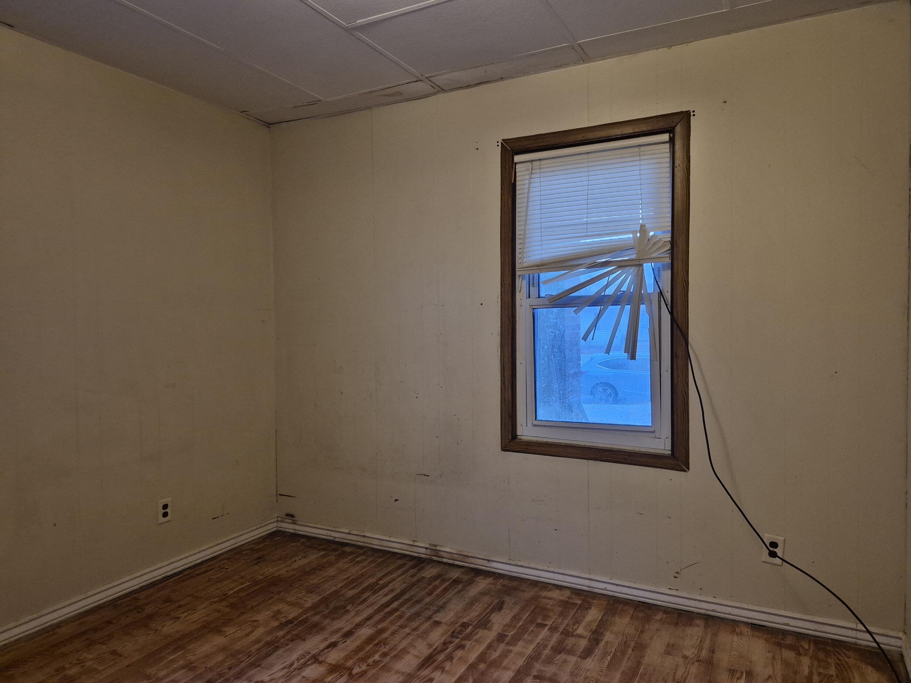 3724 Tyler Street Gary, IN 46408 - Photo 6 of 10 a view of a small space with wooden floor and a window