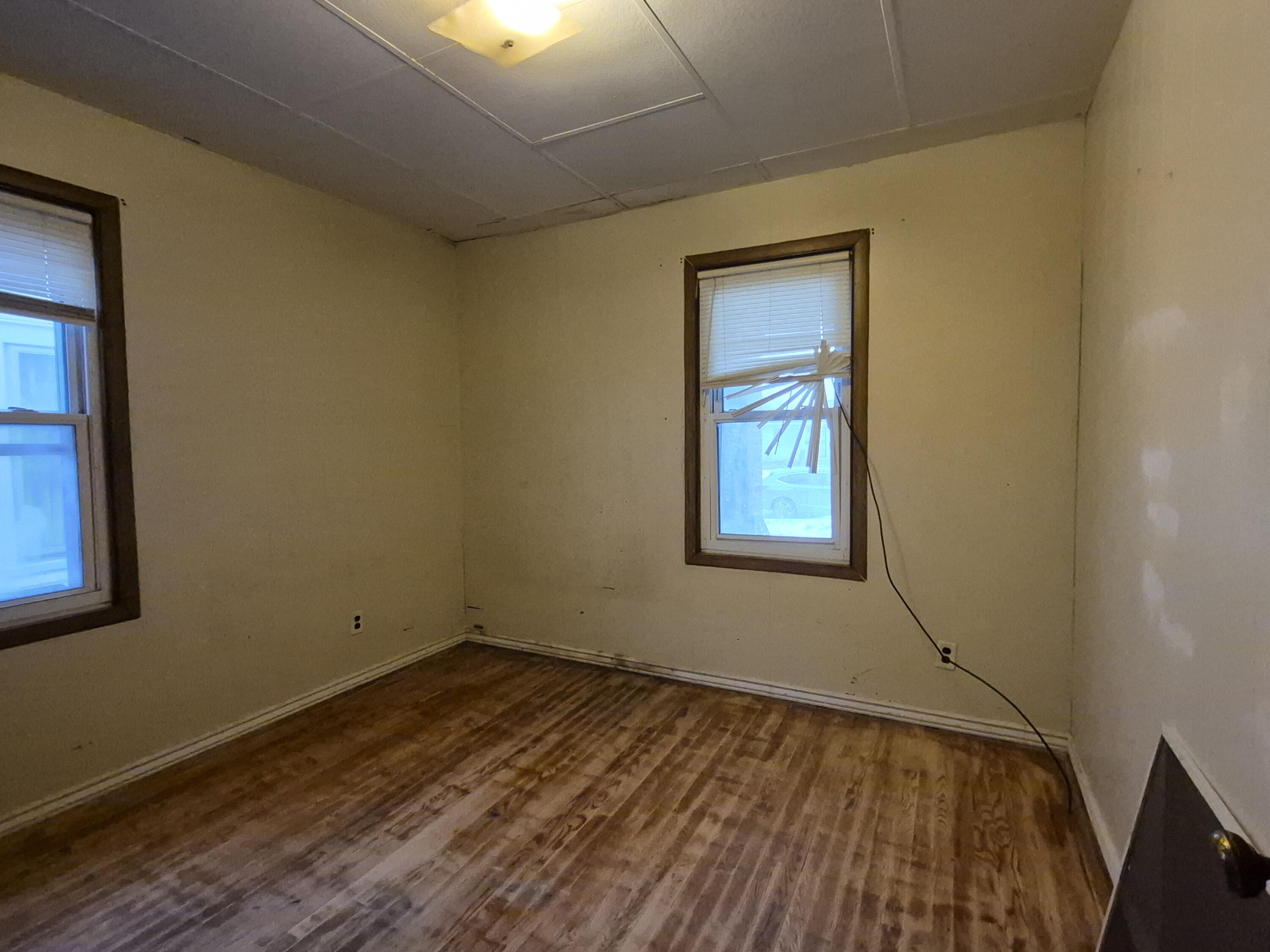 3724 Tyler Street Gary, IN 46408 - Photo 7 of 10 a view of a room with wooden floor and windows