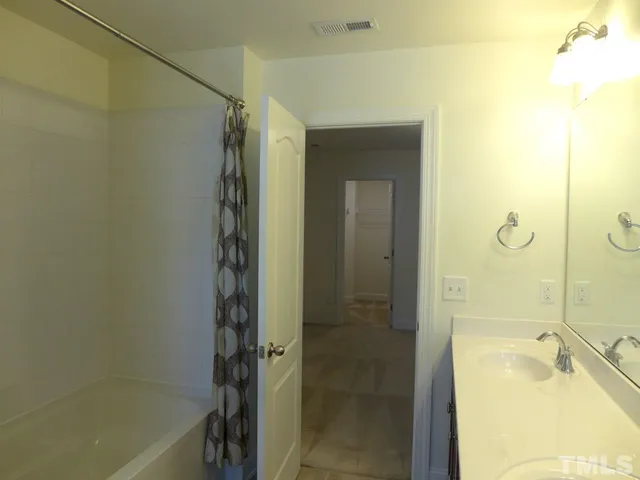 a bathroom with a tub and shower