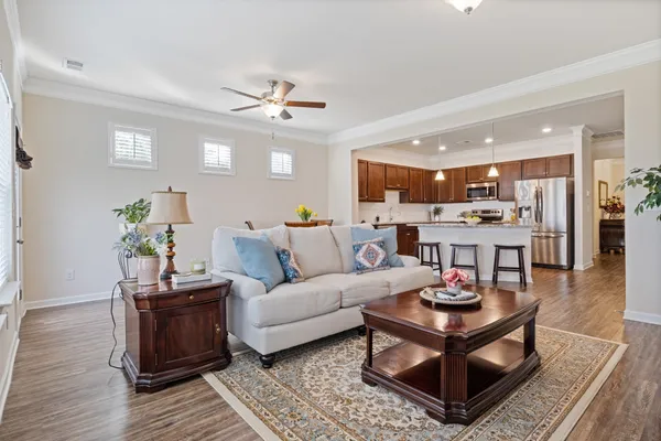 a living room with furniture and wooden floor