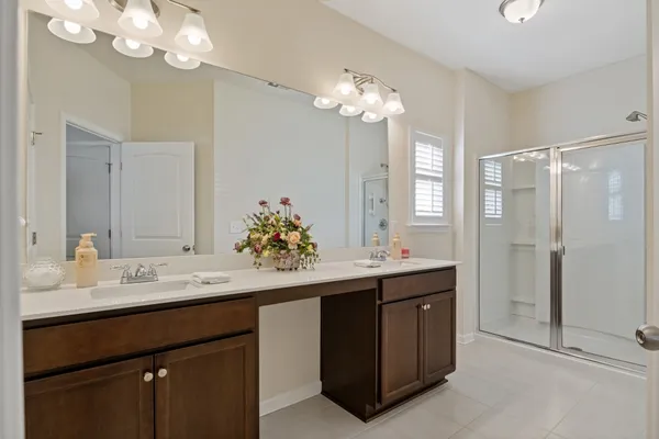 a bathroom with a sink double vanity and a mirror