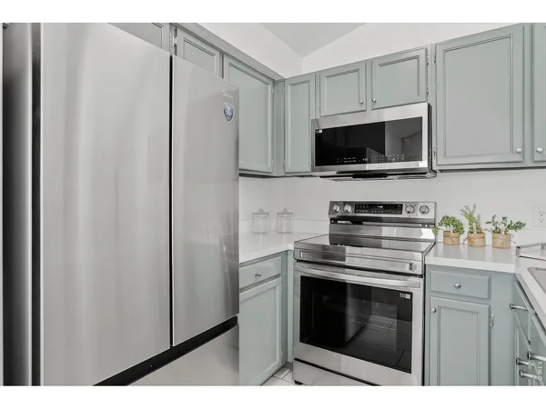 a kitchen with stainless steel appliances white cabinets and a stove