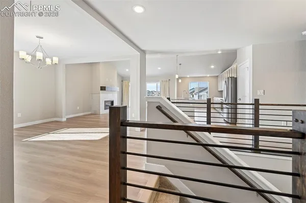a view of empty room with wooden floor and fireplace