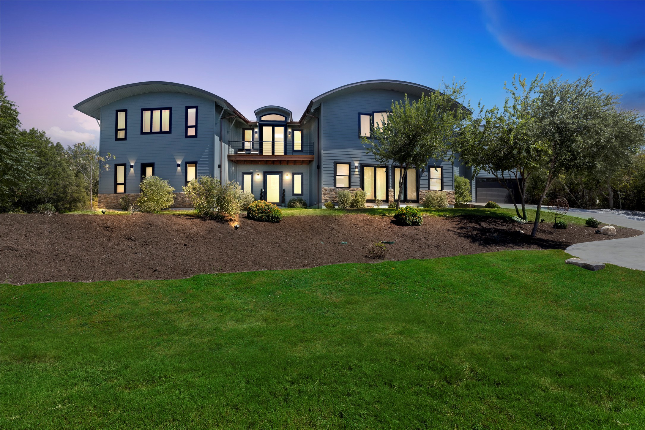 4227 Eck Lane Austin, TX 78734 - Photo 2 of 30 View of front facade with a front yard, a balcony, and stone siding