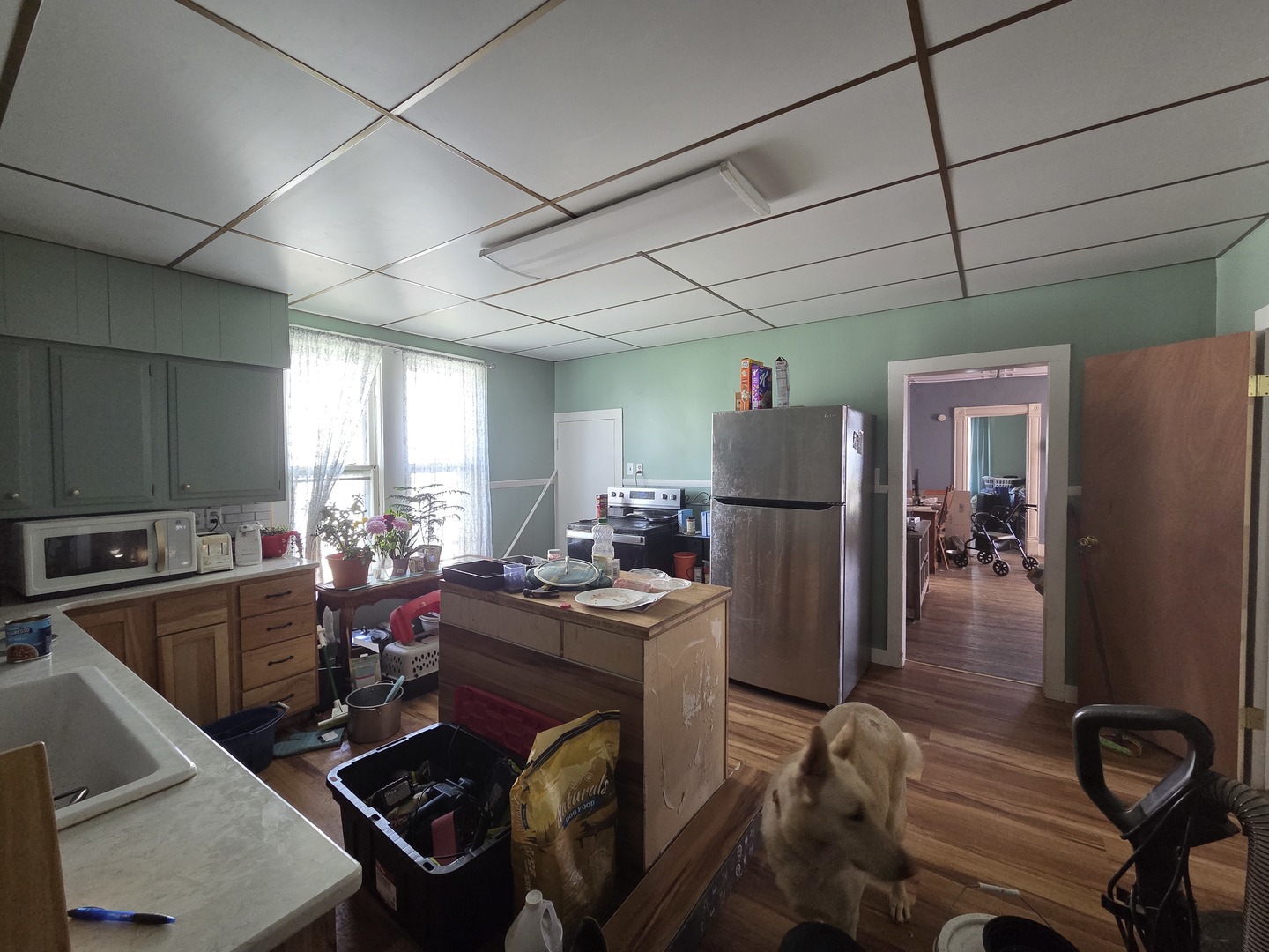 335 6th Avenue North Clinton, IA 52732 - Photo 8 of 23 a kitchen with sink refrigerator dining table and chairs