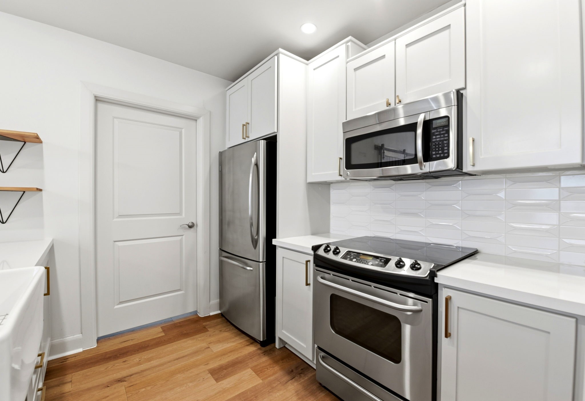 1010 Rosine Street, Unit 43 Houston, TX 77019 - Photo 12 of 48 a kitchen with stainless steel appliances white cabinets white stove and a refrigerator