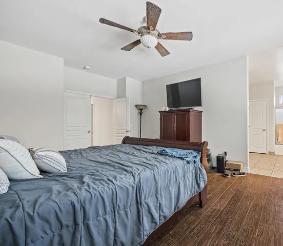 a bedroom with a bed and a television