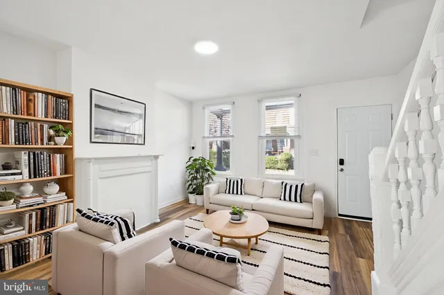 a living room with furniture and a book shelf