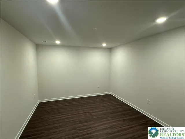 a view of room with wooden floor