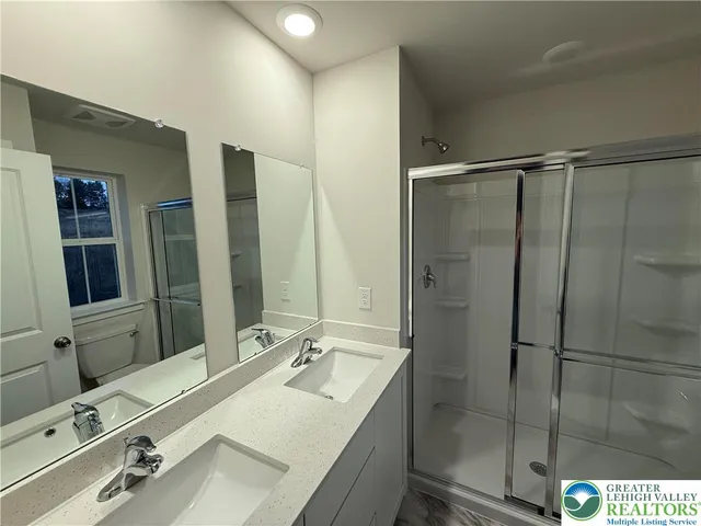 a bathroom with a sink double vanity and a mirror