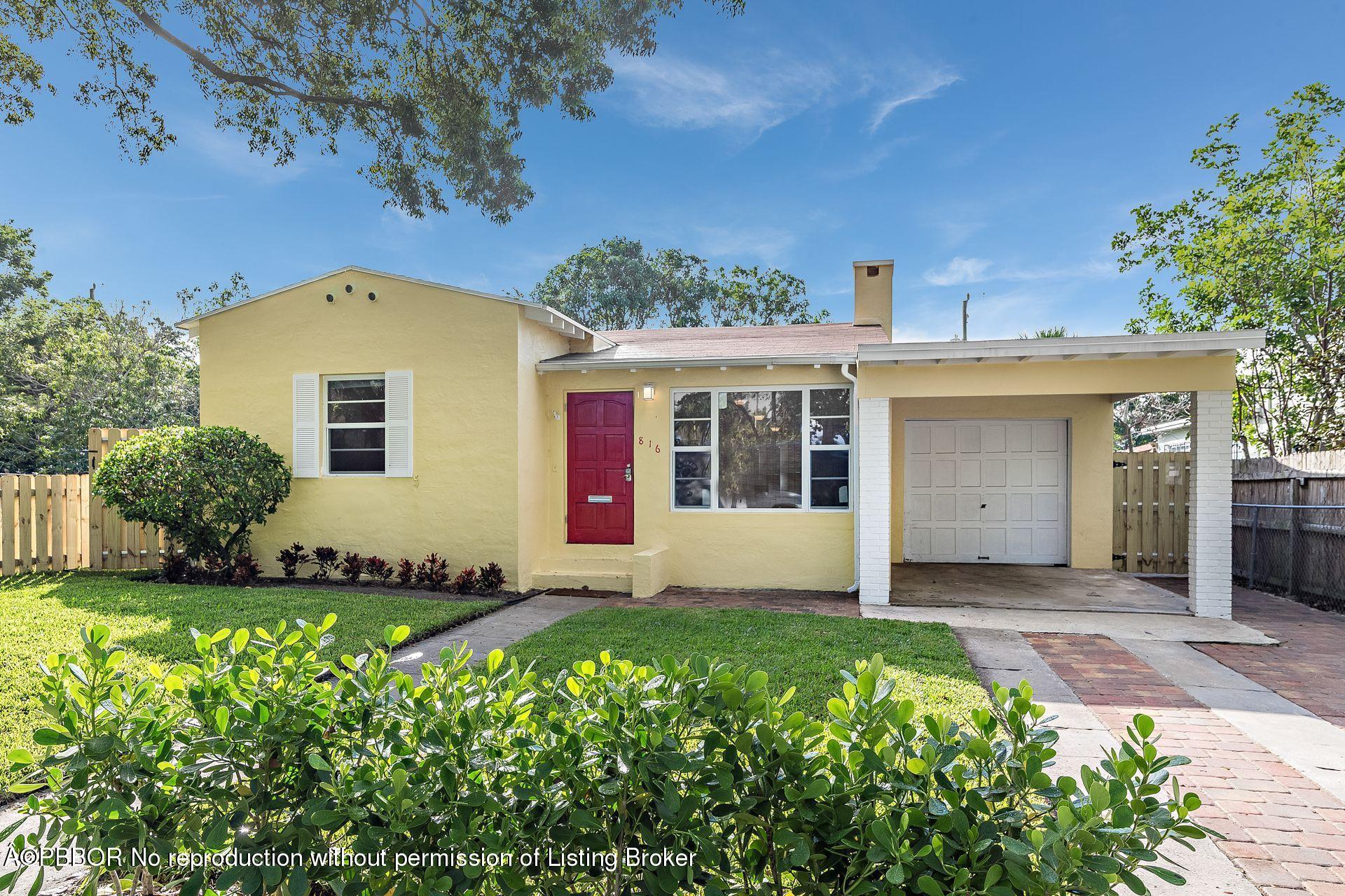816 Sunset Road West Palm Beach, FL 33401 - Photo 2 of 22 a front view of a house with a yard