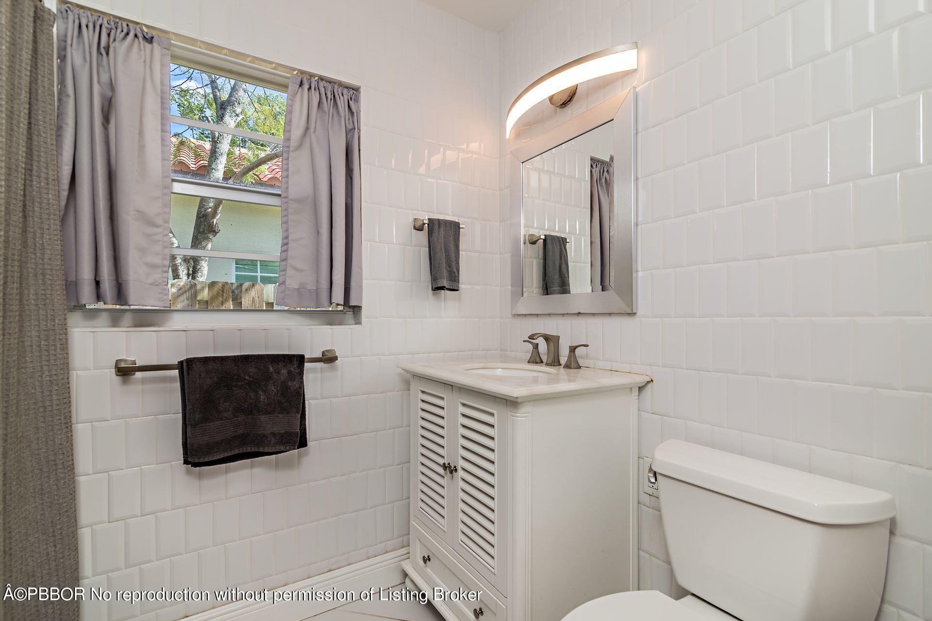 816 Sunset Road West Palm Beach, FL 33401 - Photo 13 of 22 a bathroom with a sink toilet and mirror