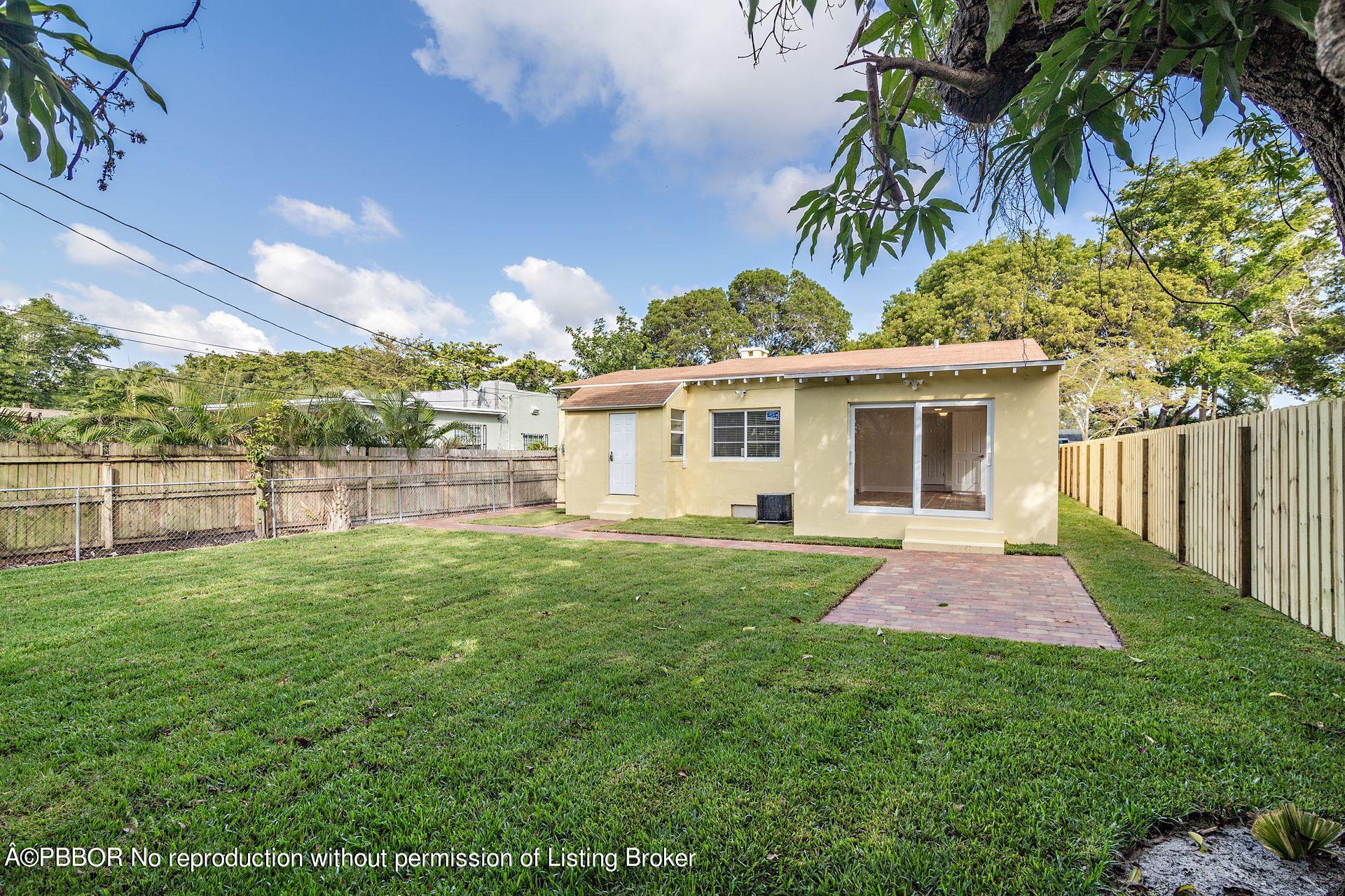 816 Sunset Road West Palm Beach, FL 33401 - Photo 15 of 22 a front view of a house with a yard