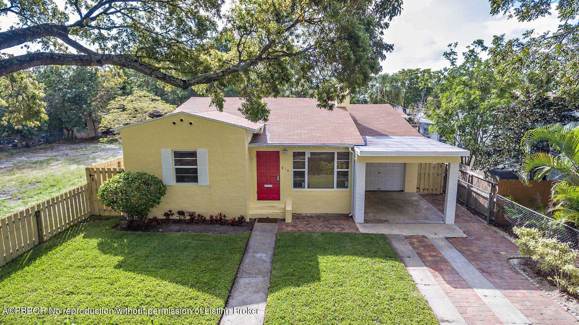 816 Sunset Road West Palm Beach, FL 33401 - Photo 19 of 22 a front view of a house with garden