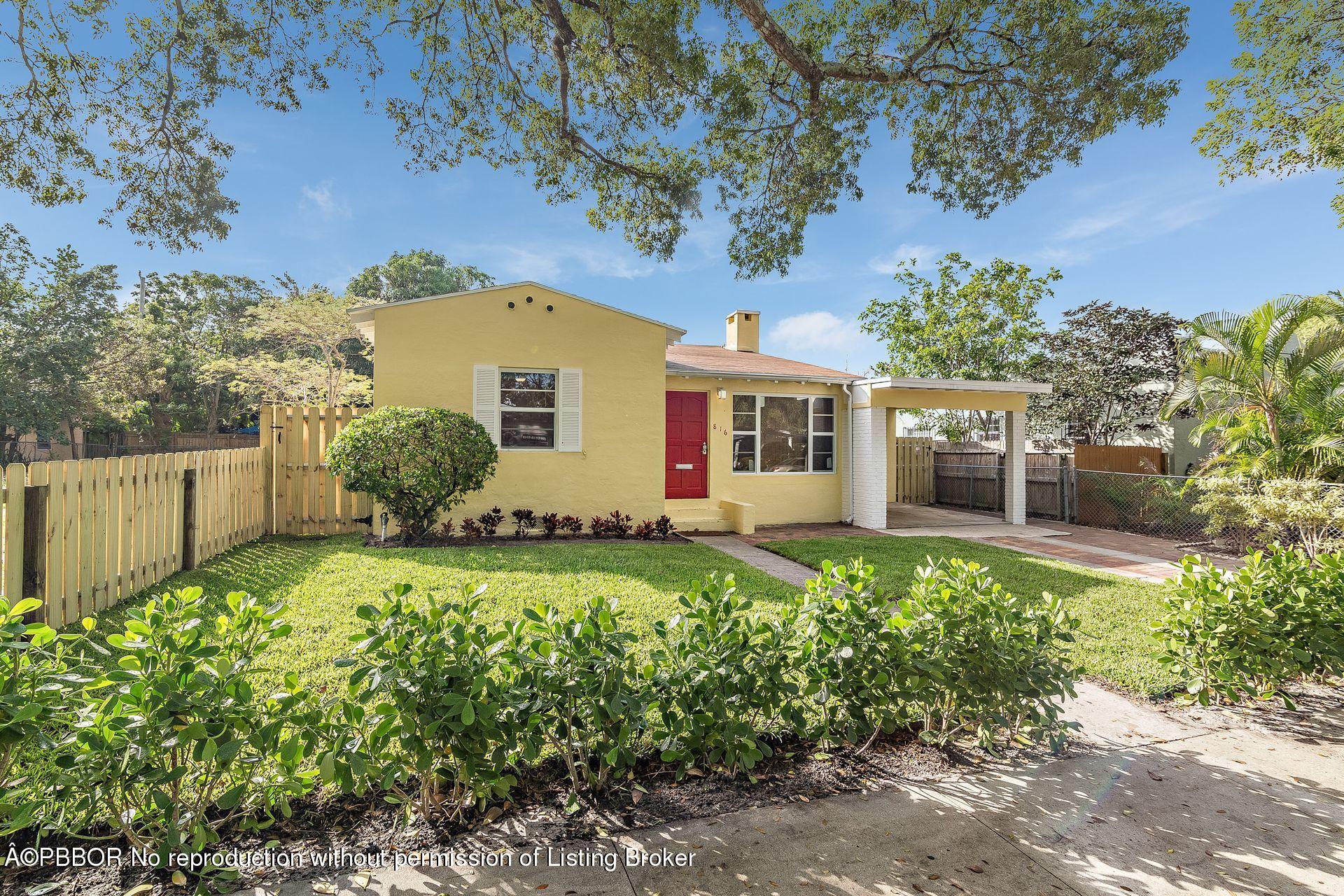 816 Sunset Road West Palm Beach, FL 33401 - Photo 3 of 22 a front view of a house with a yard