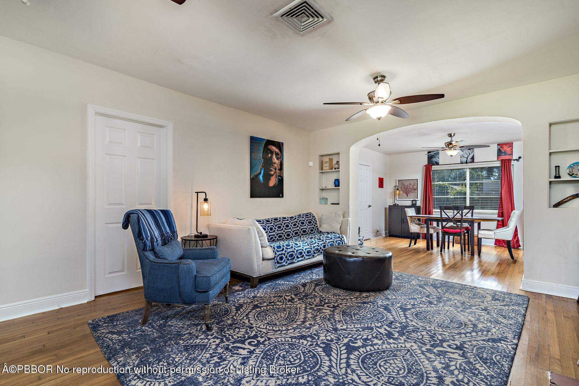 816 Sunset Road West Palm Beach, FL 33401 - Photo 5 of 22 a living room with furniture a rug and a chandelier