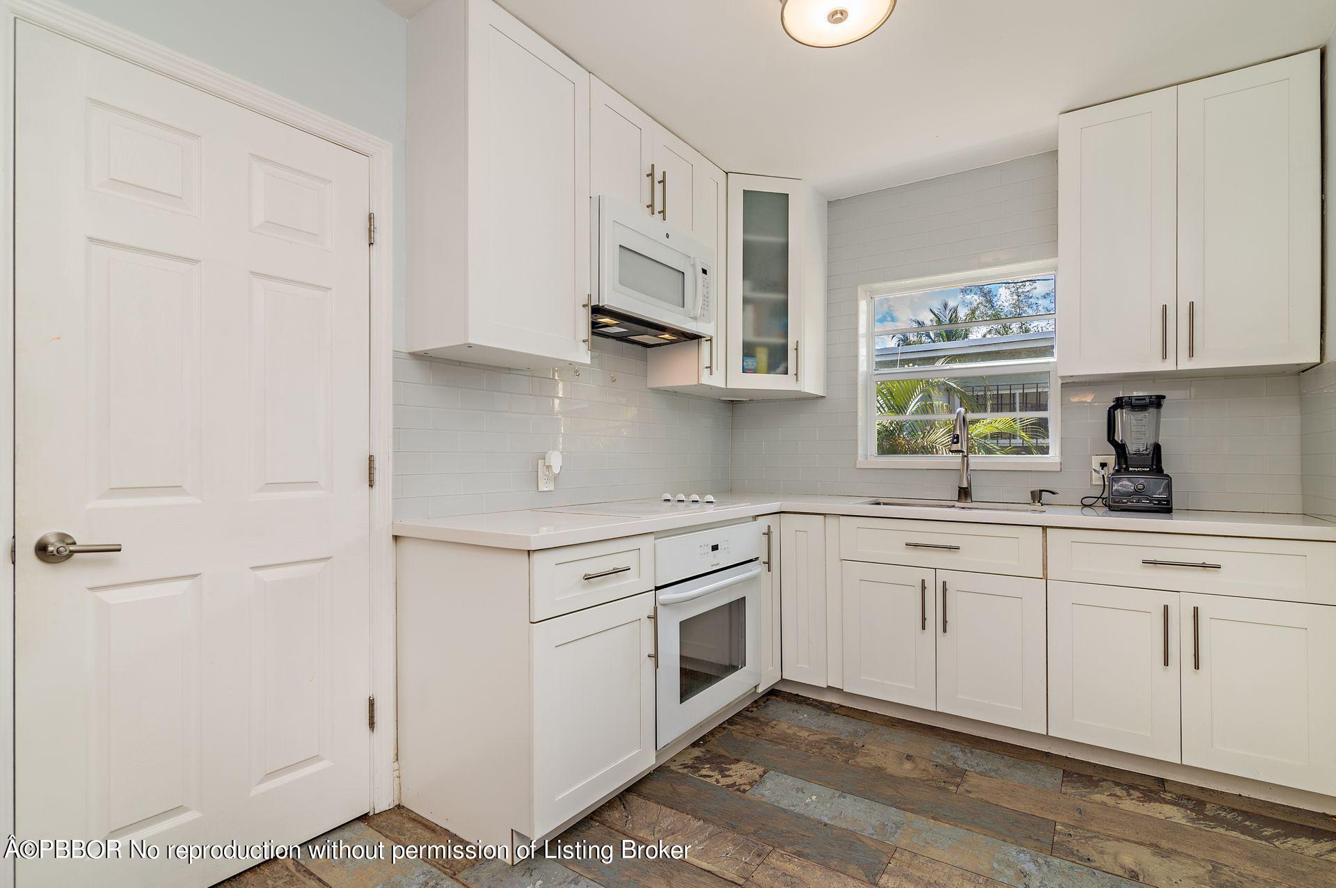 816 Sunset Road West Palm Beach, FL 33401 - Photo 9 of 22 a kitchen with cabinets appliances and a window