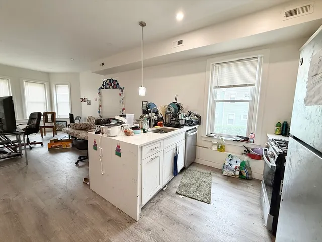 a view of living room with furniture and a large window