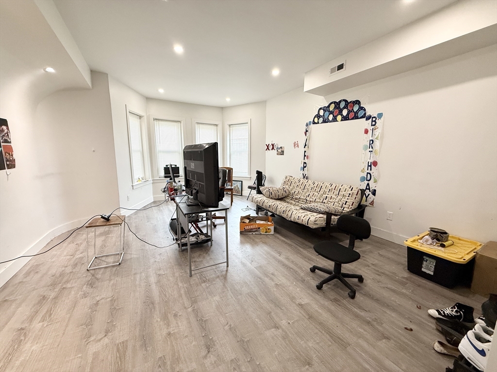 301-305 Dudley Street, Unit 2 Boston, MA 02119 - Photo 3 of 10 a living room with furniture and a wooden floor