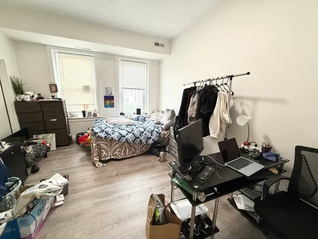 a bedroom with furniture and a window